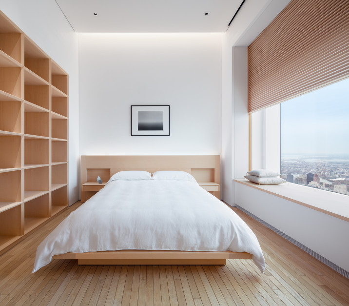 Secondary bedroom, with custom Alaskan cedar cabinetry and bed, shikkui plaster walls, chestnut wood flooring, and operable wooden screen in front of large window.