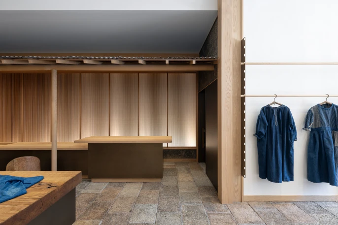View of clothing display and bronze-clad customer service counter at 45R's new clothing store in Soho, New York.