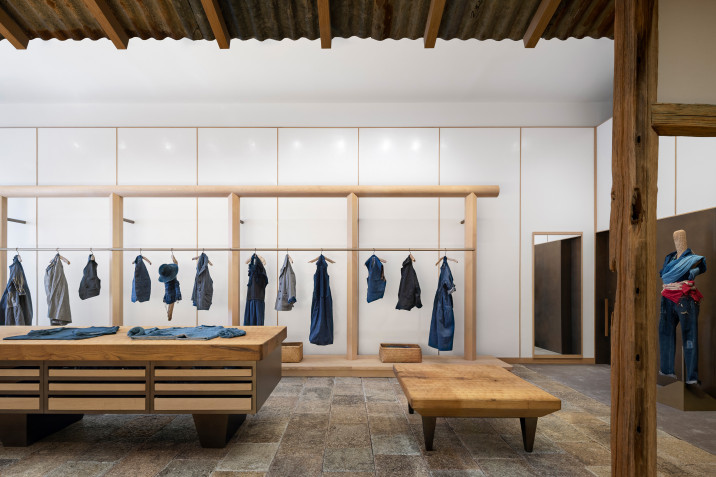 Overall view of 45R's new clothing store in Soho, New York, with clothing display rackets, display tables and recycled stone flooring.